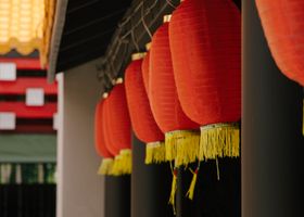 A calm corridor with soft light and a paper lantern
